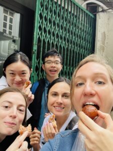 Travelers enjoying Hanoi street food with a local host